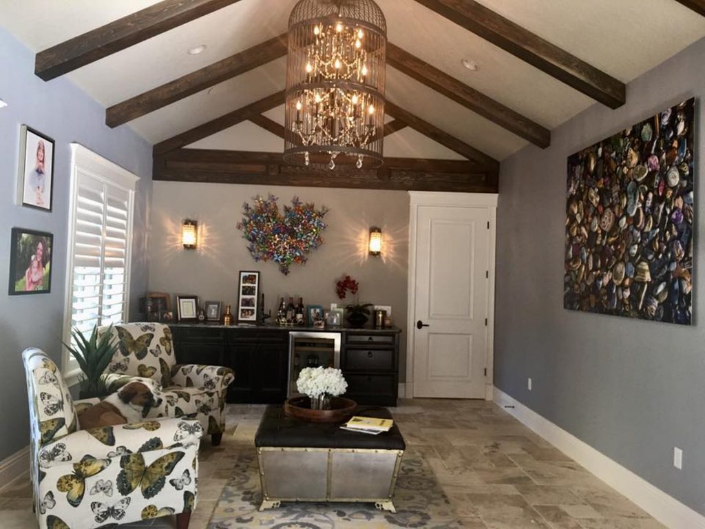 Elegant living room with chandelier and cozy seating.