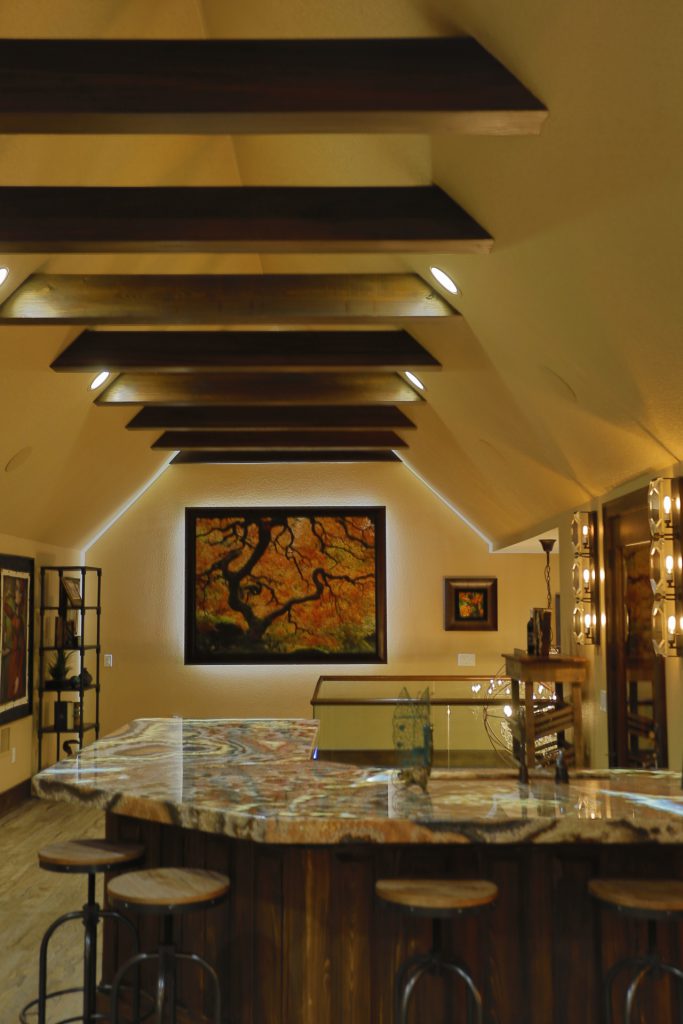 Elegant attic room with exposed beams and warm lighting.