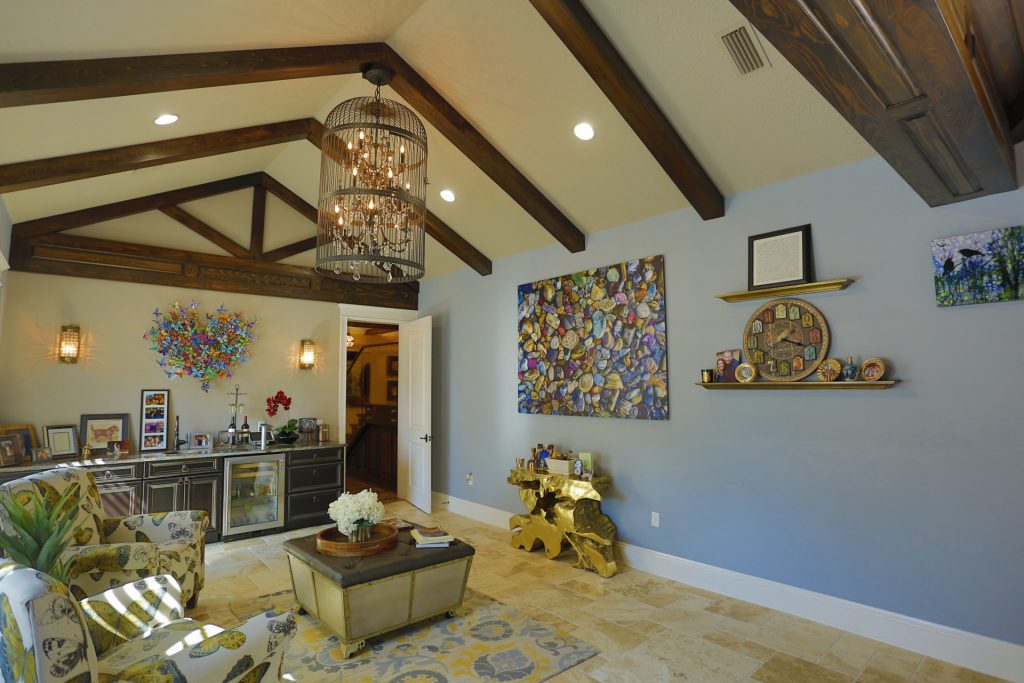 Elegant living room with vaulted ceiling and chandelier.