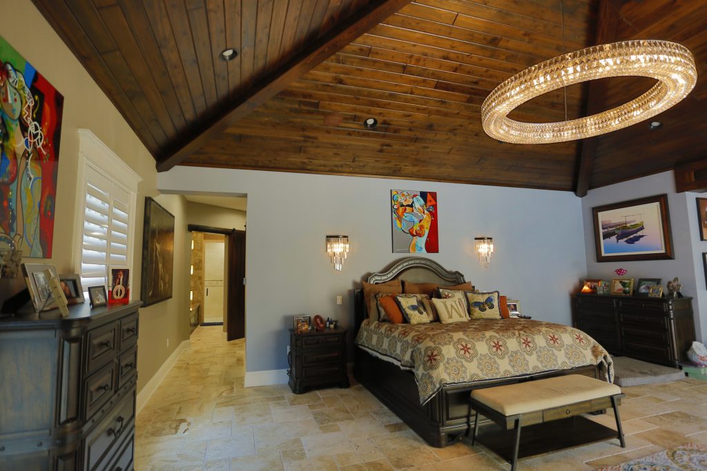 Cozy bedroom with wooden ceiling and elegant decor.