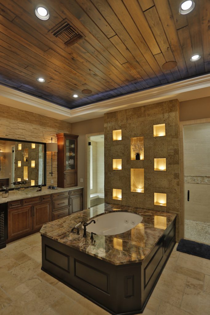 Luxurious bathroom with a marble bathtub and decorative wall niches.